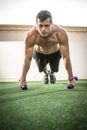 Handsome muscular young man doing push up exercise with weights outdoors Royalty Free Stock Photo