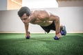 Handsome muscular young man doing push up exercise with weights outdoors Royalty Free Stock Photo