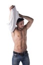 Handsome muscular young man taking off t-shirt Royalty Free Stock Photo