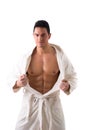 Handsome muscular young man wearing white bathrobe, isolated Royalty Free Stock Photo