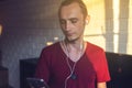 Handsome, a music lover listens to music with headphones with a mobile phone on the media and large speakers. Royalty Free Stock Photo