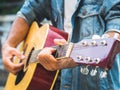 Handsome musician playing acoustic guitar on blur background. Wo Royalty Free Stock Photo