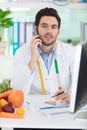 handsome nutritionist in office on phone Royalty Free Stock Photo