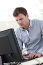 Handsome office worker working on computer