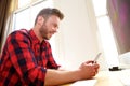 Handsome older man sitting and using cellphone Royalty Free Stock Photo