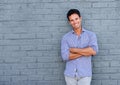 Handsome older man smiling with arms crossed