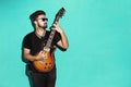 Handsome passionate cool young brunette playing electric guitar Royalty Free Stock Photo