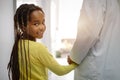 Pediatrician doctor smiling with his little girl patient at hospital Royalty Free Stock Photo