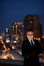 Handsome Persian businessman against view of the city at night Royalty Free Stock Photo