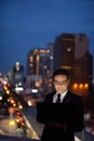 Handsome Persian businessman against view of the city at night Royalty Free Stock Photo