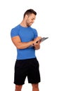 Handsome personal trainer with a clipboard