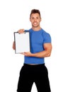 Handsome personal trainer with clipboard