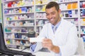 Handsome pharmacist scanning medicine box