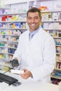 Handsome pharmacist scanning medicine box