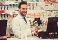 Handsome pharmacist at work