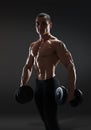 Handsome power athletic man bodybuilder doing exercises with dum Royalty Free Stock Photo