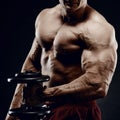 Handsome power athletic man in training pumping up muscles with Royalty Free Stock Photo