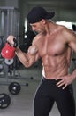Handsome powerful athletic man doing biceps exercise with kettle bell Royalty Free Stock Photo