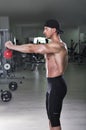 Handsome powerful athletic man doing shoulder exercise with kettle bell Royalty Free Stock Photo
