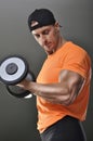 Handsome powerful athletic man performing biceps exercise with dumbbell Royalty Free Stock Photo