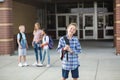 Handsome pre-adolescent teen boy student hanging out with friends after school. Royalty Free Stock Photo