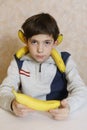 Handsome preteen boy in funny banana collar