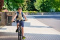 Handsome preteen boy going to school on bike. Teenager ride bicycle. Safe way to high school. Happy child boy with