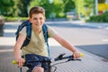 Handsome preteen boy going to school on bike. Teenager ride bicycle. Safe way to high school. Happy child boy with