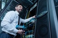 Handsome professional technician repairing the network server