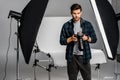 handsome professional young photographer using camera Royalty Free Stock Photo