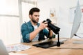 handsome professional young photographer using camera Royalty Free Stock Photo