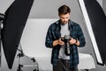 handsome professional young photographer using photo camera Royalty Free Stock Photo