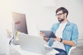 Handsome programmer wearing glasses in an office