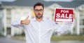Handsome real estate agent holding banner house for sale. House with land and insurance. Business man real estate agent Royalty Free Stock Photo