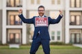 Handsome real estate agent holding banner house for sale. House with land and insurance. Man real estate agent in Royalty Free Stock Photo