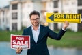 Handsome real estate agent holding banner house for sale and for rent. House with land and insurance. Business man real Royalty Free Stock Photo