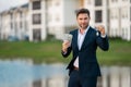 Handsome real estate agent holding money dollars and house keys. Man real estate agent in business suit presenting the Royalty Free Stock Photo