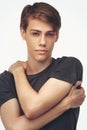 Handsome relaxed man in t-shirt. Portrait of young seductive guy, looking at camera, white studio background. Posing for Royalty Free Stock Photo