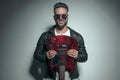 Handsome rock singer holding his electric guitar upside down