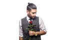 Handsome romantic happy man with rose flower.
