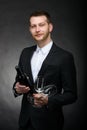 Handsome romantic man holding bottle and glasses of wine