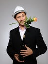 Handsome romantic man with rose flower and vine