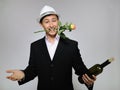 Handsome romantic man with rose flower,vine bottle