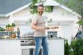 Handsome 40s man preparing barbecue. Male cook cooking meat on barbecue grill. Guy cooking meat on barbecue for summer Royalty Free Stock Photo