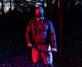 Handsome scary muscular man working out with weightlifting chains at dusk in the park while wearing training mask, functional Royalty Free Stock Photo