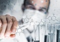 Young scientist mixing reagents in glass flask in clinical laboratory Royalty Free Stock Photo