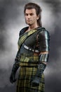 Handsome Scottish Warrior Prince wearing traditional tartan kilt and body armour / armour