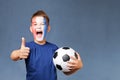 Handsome screaming french fanboy holds soccer ball and gesturing thumbs up Royalty Free Stock Photo