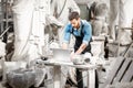 Sculptor working with laptop in the studio Royalty Free Stock Photo