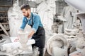 Sculptor working with laptop in the studio Royalty Free Stock Photo